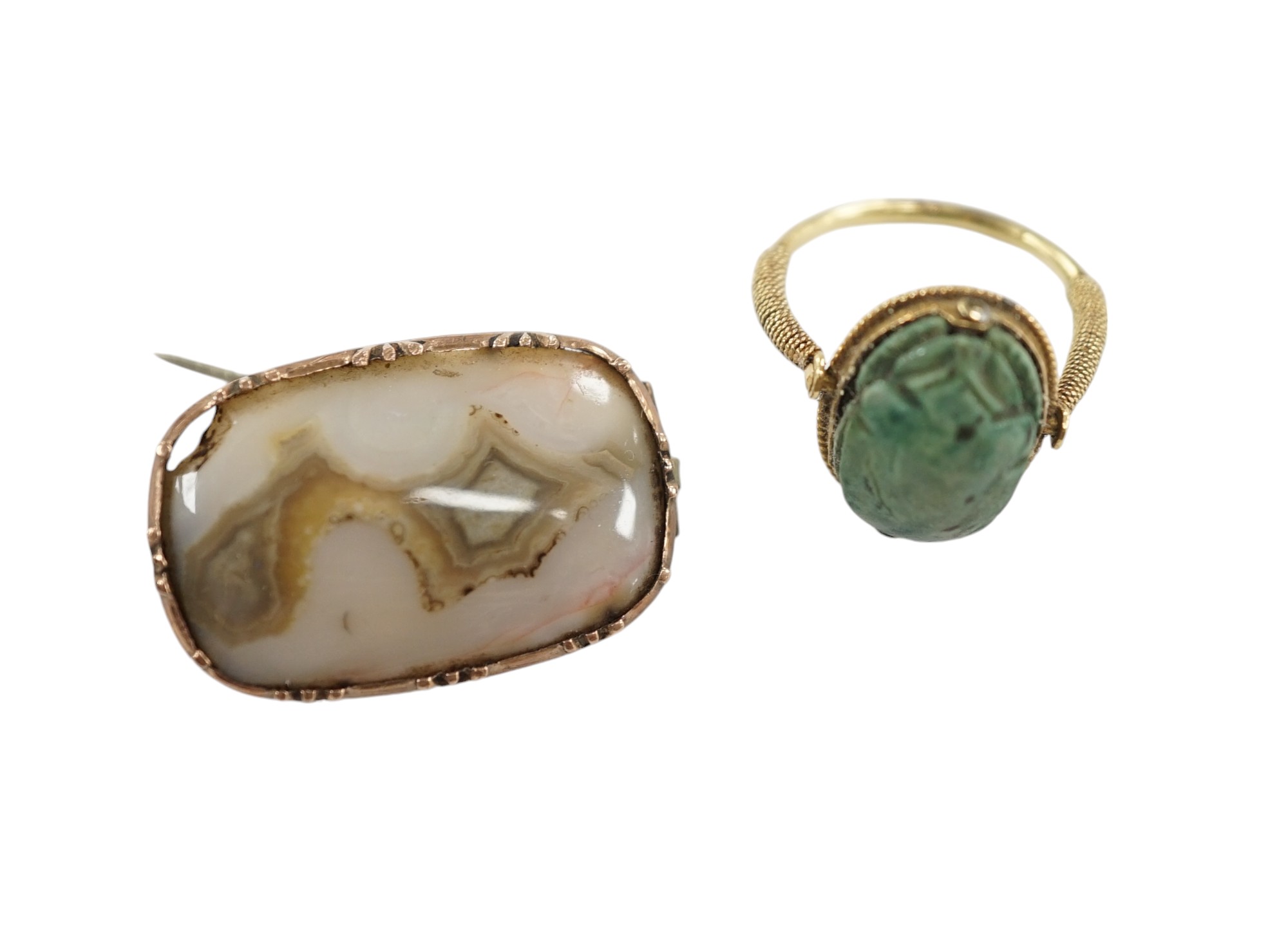 An antique yellow metal 'Scarab' ring and a banded agate set brooch. Condition - poor to fair